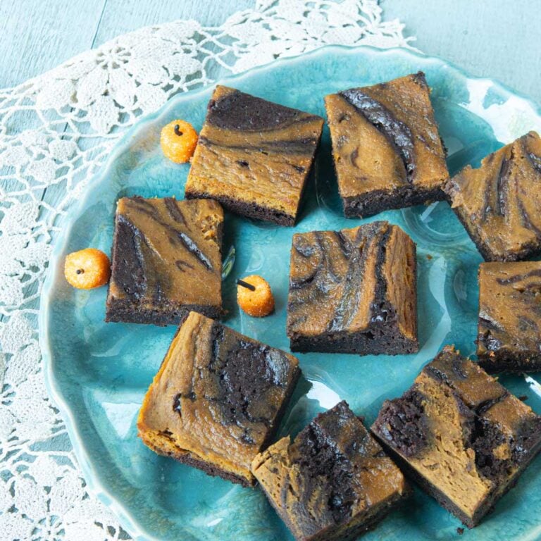 plate of pumpkin brownies with tiny marshmallow pumpkins