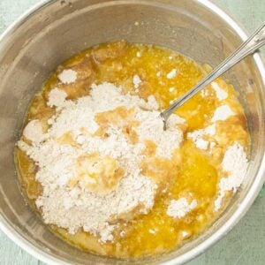 pouring butter over flour for streusel