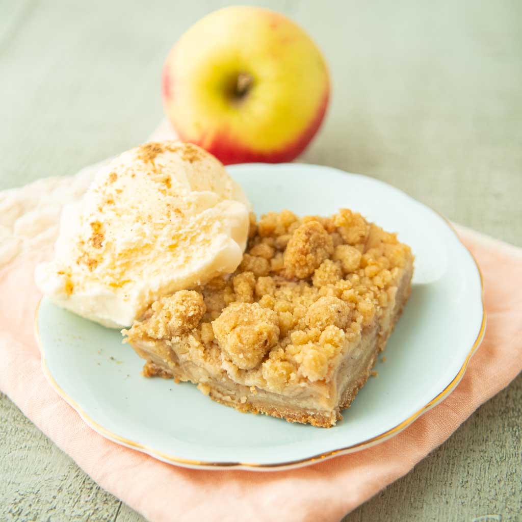apple crumb bar with ice cream and whole apple
