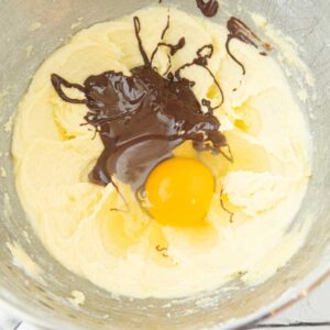 adding melted chocolate and egg to batter