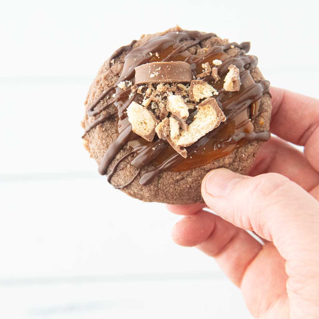 hand holding a twix cookie