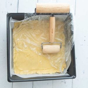 rolling dough into pan for crust