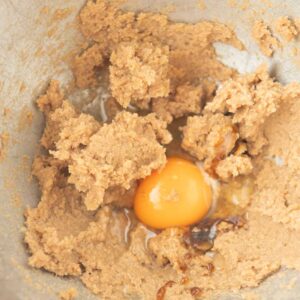 adding egg and vanilla to cookie batter