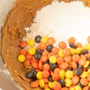 adding flour and Reese's pieces to cookie dough