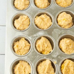 vegan cornbread batter in mini muffin tin