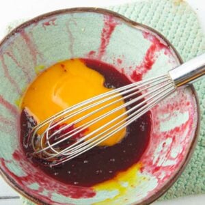 whisking cranberry puree with egg yolks
