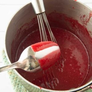 cranberry curd coating the back of a spoon