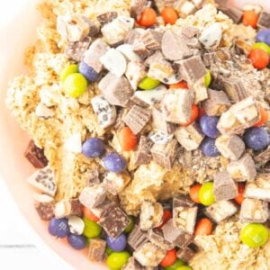 adding candy to Monster Cookies