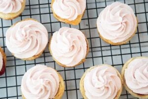piping cranberry whipped cream onto cranberry tarts