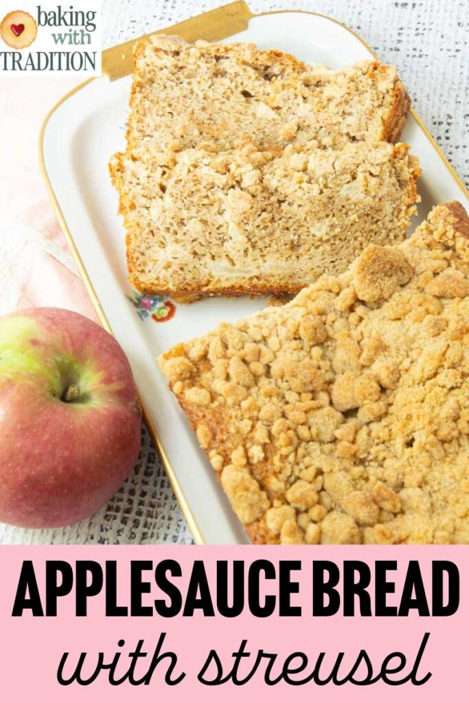 sliced applesauce bread with crumb topping on plate with whole apple and text overlay