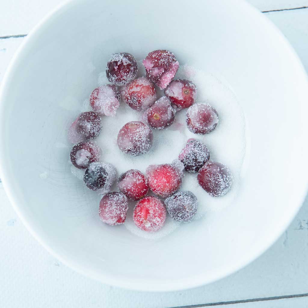 tossing sugared cranberries in sugar
