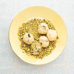 rolling dough in pistachios