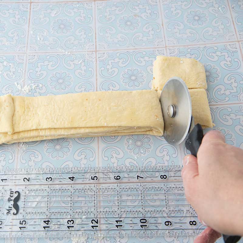 cutting stacks of dough into fan rolls