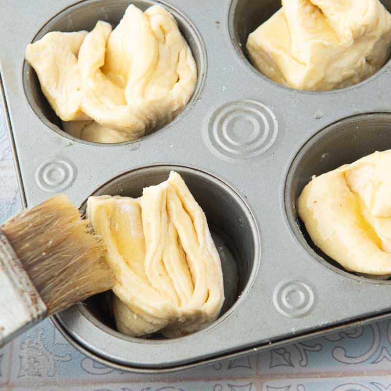 brushing fan rolls with butter