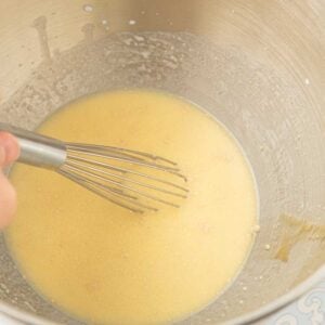 whisking eggs into milk
