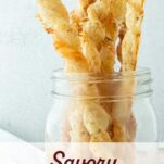 puff pastry straws standing in glass jar, text overlay