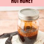 hot honey next to whole chile in jar