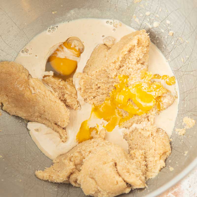 adding eggs and milk to butter and sugar