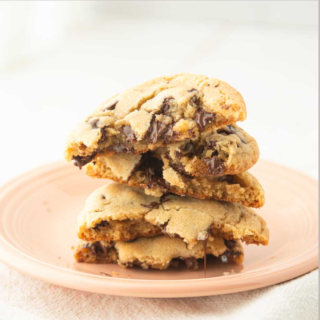 chocolate chip cookie halves stacked on plate