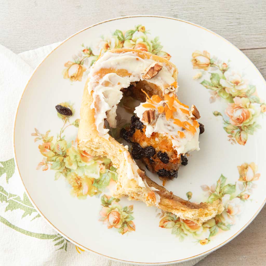 carrot cake cinnamon roll on plate, unwound