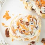 closeup of carrot cake cinnamon rolls on plate