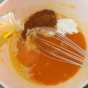 pouring oil into carrot cake batter