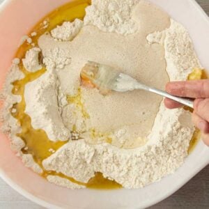 breaking egg with fork in yeast water