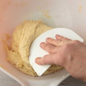 folding dough over on itself with dough scraper