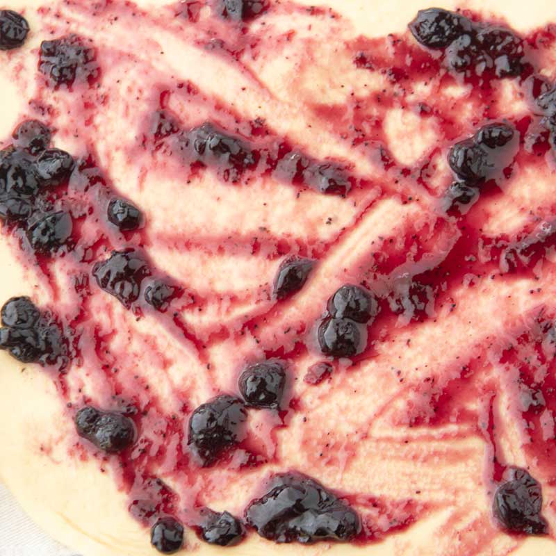 blueberry jam spread on dough