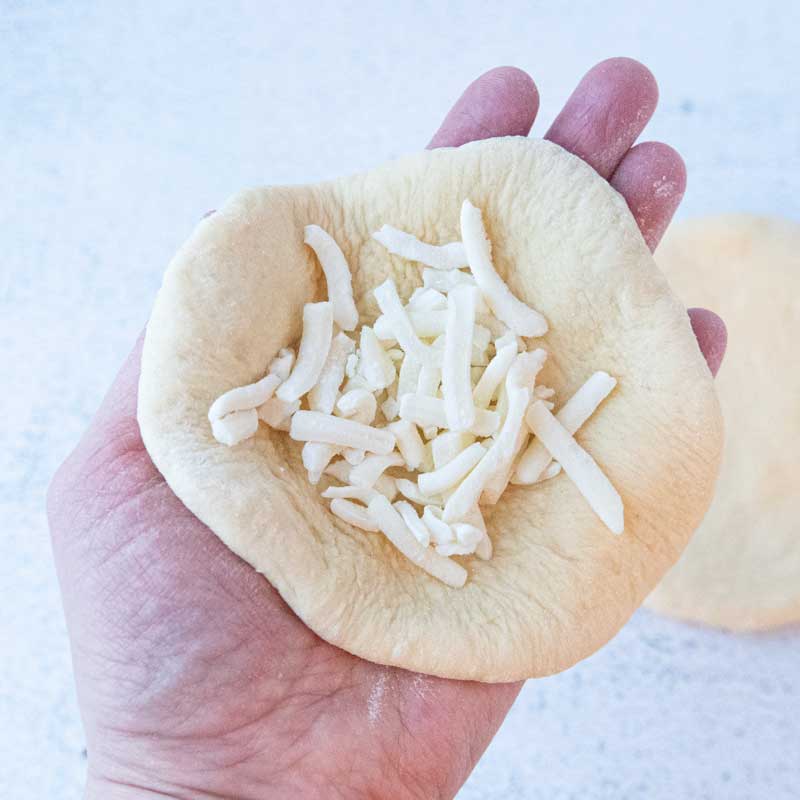 filling dough circle with cheese