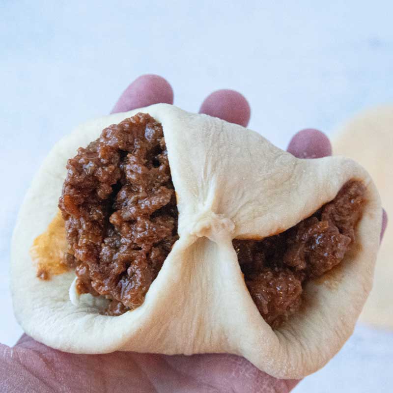 folding dough over sloppy joe filling