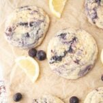 lemon blueberry cookies next to lemon slices and blueberries