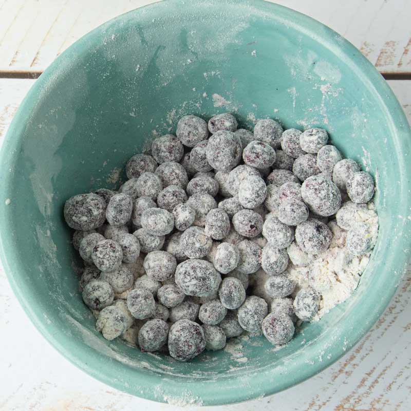 tossing blueberries with flour