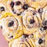lemon blueberry rolls on wood plate, text overlay