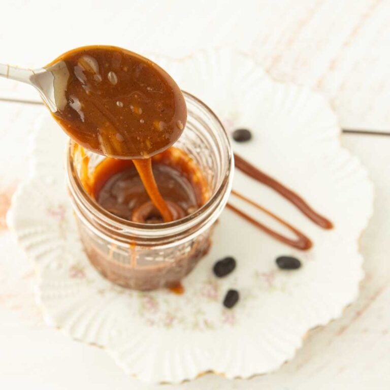 pan of coffee caramel sauce, spoon drizzling coffee caramel sauce into jar