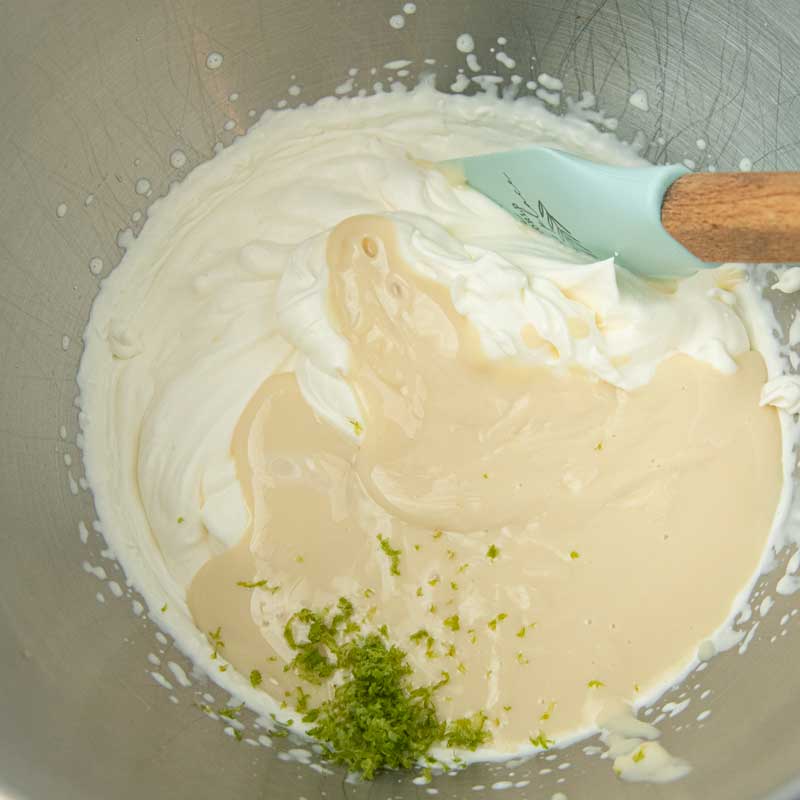 stirring lime zest and sweetened condensed milk into whipped cream