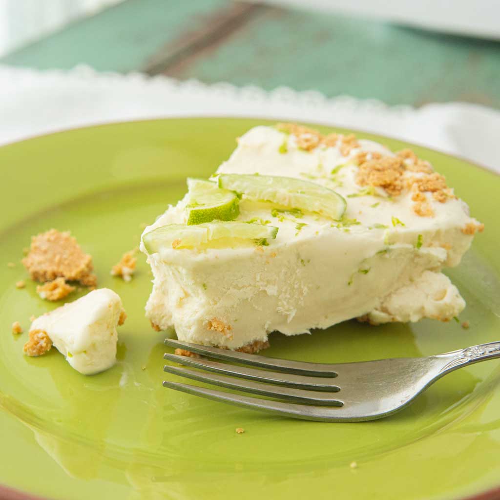 side view of frozen key lime pie on plate with fork