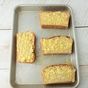 garlic butter spread on bread on sheet tray
