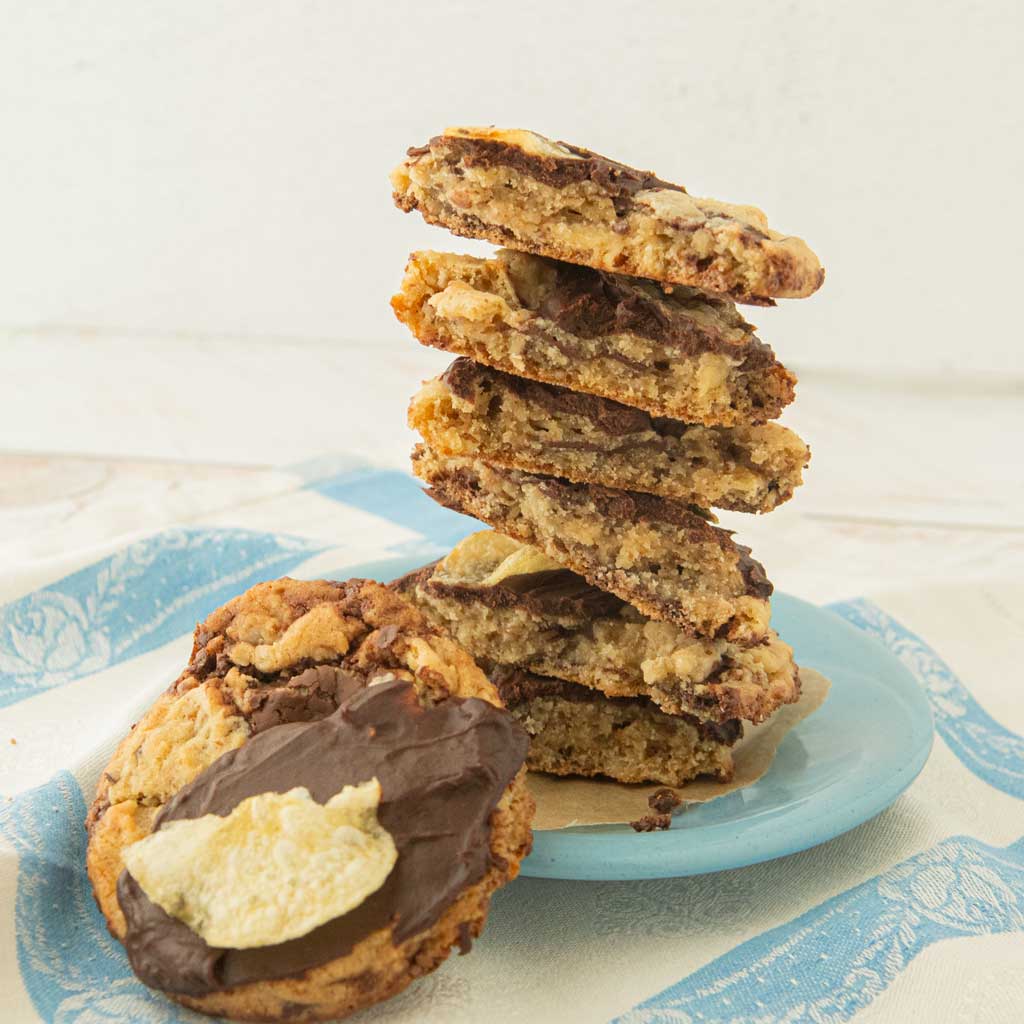 stack of broken potato chip cookies next to whole potato chip chocolate chip cookie