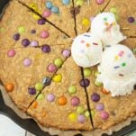 top view of oatmeal skillet cookie with m&ms and scoops of ice cream