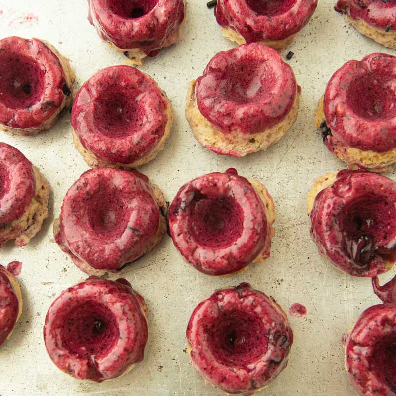 blueberry mini donuts after dipping in glaze