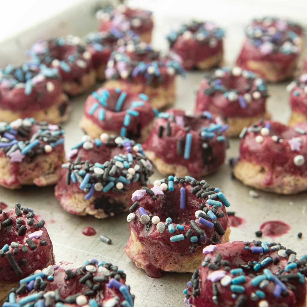 blueberry glaze on blueberry mini donuts with sprinkles
