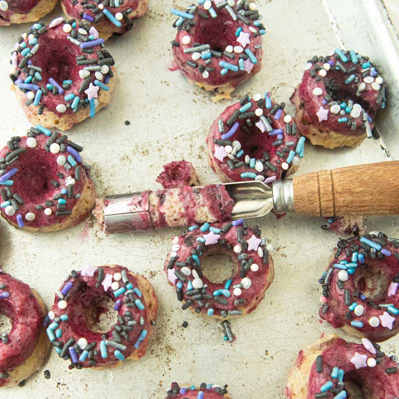 cutting out centers on mini blueberry donuts with apple corer