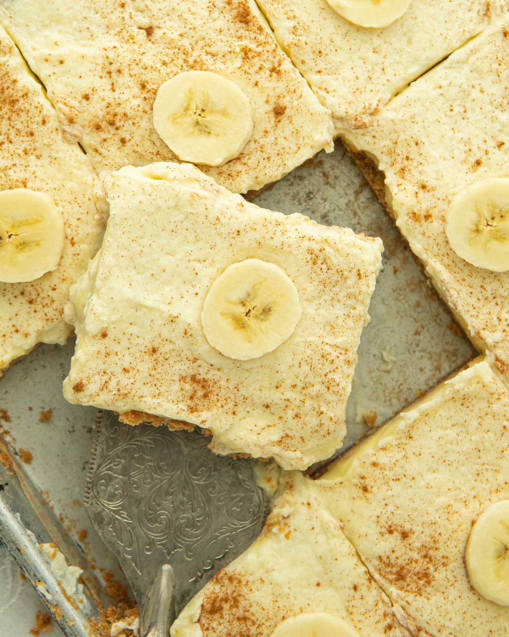 banana pudding pie on server on tray of banana pudding pie