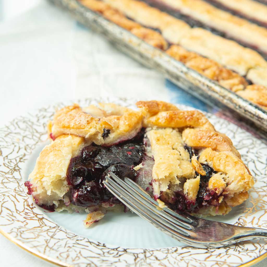 slice of berry slab pie and fork on plate