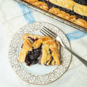 top view of slice of berry slab pie and fork on plate