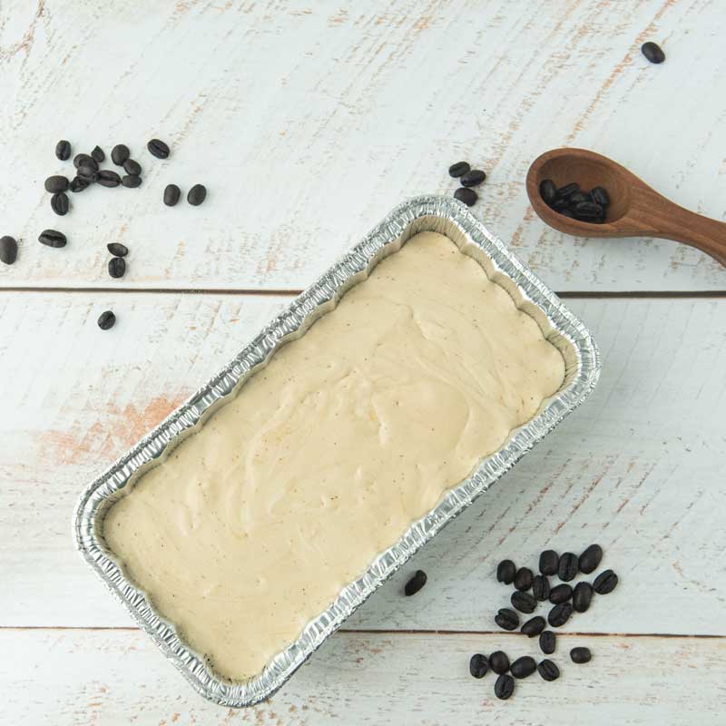 coffee ice cream in loaf pan with coffee beans and coffee scoop