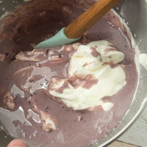 folding cherry sweetened condensed milk into whipped cream