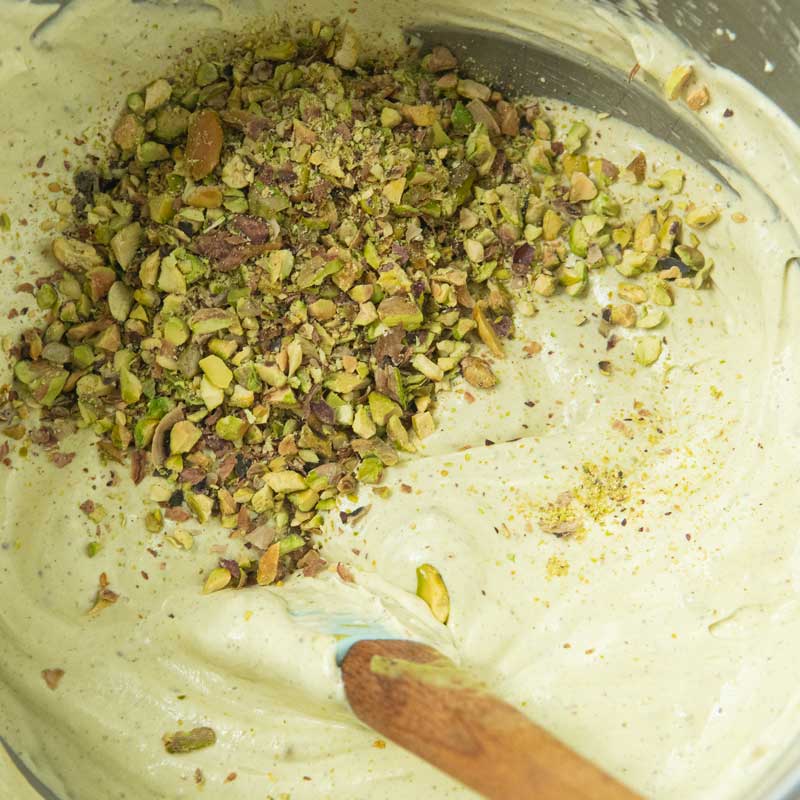 folding chopped pistachios into ice cream base