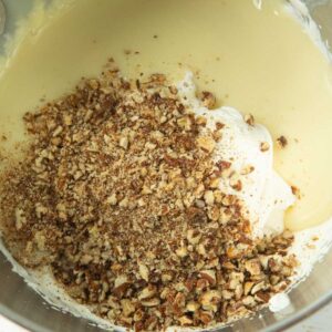 adding chopped candied pecans to ice cream base